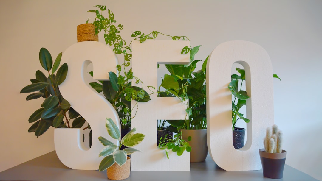 cta-bg Vibrant and nature-inspired office setting at an SEO agency, featuring large SEO letters prominently displayed on a modern desk. The letters are adorned with an abundance of lush green plants, creating a refreshing and natural atmosphere. The combination of digital focus and greenery brings a unique balance of productivity and tranquility to the workspace.