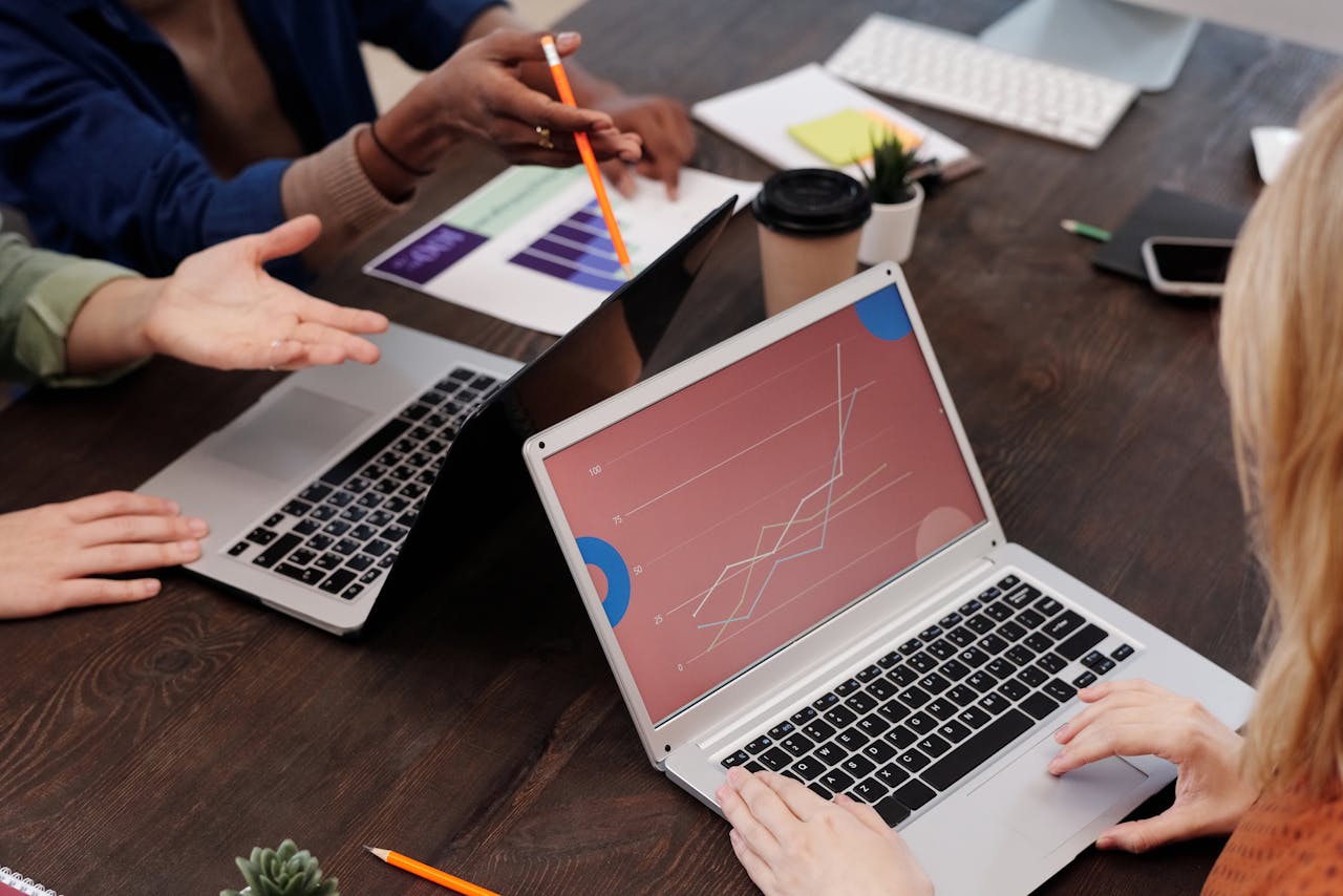 contact-img Group of professionals discussing data analytics in a modern office setting.